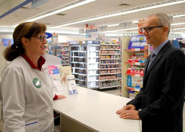 David Gardner with pharmacist Tena Taylor, owner of a Shoppers Drug Mart.