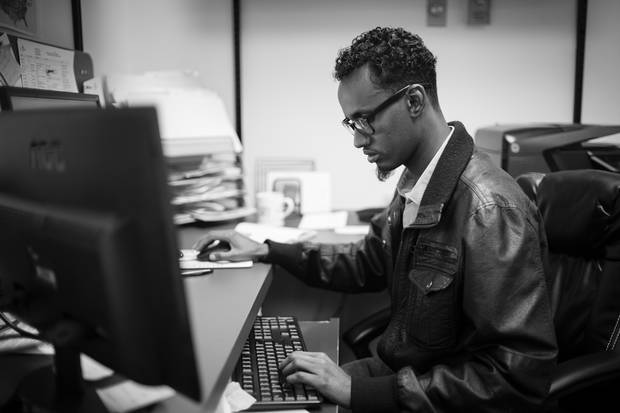 Yahya Samatar, from Somalia, works as a fundraising co-ordinator at Creaddo Group in Winnipeg. He first came to Canada in August 2015, by hiking and swimming north in the Red River. Since then he has been granted refugee status and sends money home to to support his family.