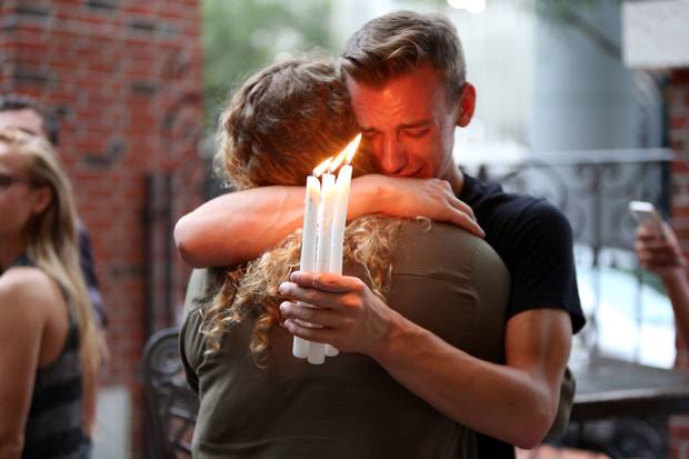 June 12, 2016: Brett Morian, from Daytona Beach, hugs an attendee during a candlelight vigil in Orlando, Fla. A shooting at the LGBT Pulse nightclub killed 49 people. Before the Las Vegas attack this week, Pulse was the deadliest U.S. shooting in recent history.