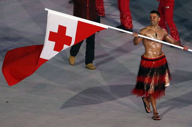 Pita Taufatofua of Tonga carries the national flag at the opening ceremonies.