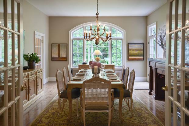 The dining room has doors opening to a balcony.