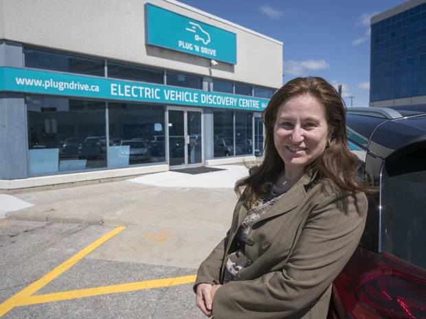 Cara Clairman, president of the Electric Vehicle Discovery Centre in Vaughan, Ont., stands outside the non-profit’s retail location on Monday. The centre officially opens next week.