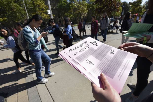 Oct. 5, 2016: A volunteer hands out a leaflet explaining gender issues and language at a rally outside the University of Toronto’s Sidney Smith Hall over the Jordan Peterson controversy.