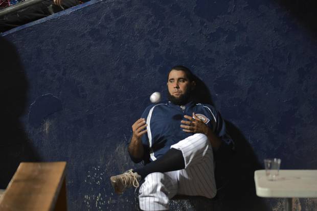 Ismel Jimenez in the Quebec Capitales dugout. Four Cuban baseball players were legally allowed to leave the country to play baseball in Canada for the Quebec Capitales. This is a new venture for Cuba which is now only beginning to see a thaw in it's relationship with the United States.