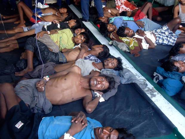 Exhausted and starved Rohingya refugees from Myanmar rest onboard a Sri Lanka naval ship in February, 2013 after being rescued from their disabled wooden vessel.