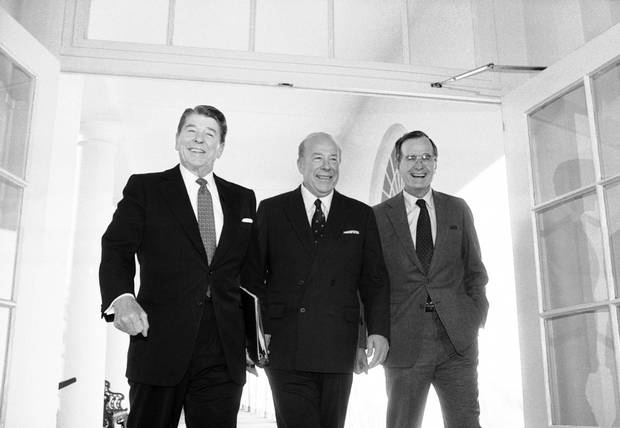 Secretary of State George Shultz, center, walks with President Ronald Reagan and Vice President George Bush on his arrival at the White House in January 1985 after two days of arms talks with the Soviet Union in Geneva. 