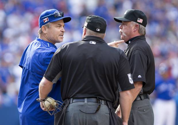 Toronto Blue Jays manager John Gibbons (5) argues with umpire crew chief Jim Joyce, right, and home plate umpire Marvin Hudson before being ejected during ninth inning Americain League MLB baseball action against the Boston Red Sox in Toronto on Sunday, September 11, 2016.