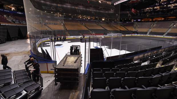 Following the Toronto Maple Leaf's final playoff game, workers convert the Air Canada Centre from a hockey rink to a basketball court on April 24 2017 in preparation for the Toronto Raptors basketball team's game tonight.