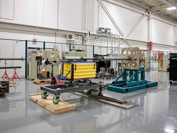 At the mock-up facility, workers put Promation’s loading table through its paces. Its job is to shove 13 fuel bundles into each fuel channel, which is then loaded into the core.