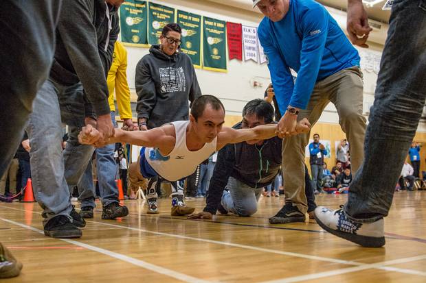 Russia's Denis Longortov competes in the airplane at the 2018 Arctic Winter Games. The airplane is not a traditional game and was added to the Games in the 1990s. It requires the competitor to maintain an iron cross position while being carried around a gymnasium. At the Games in Greenland in 2016, the airplane became a timed event, after previously being decided on distance. Nunavik's Larry Thomassiah ended up winning gold this year with a time of 56.83 seconds.