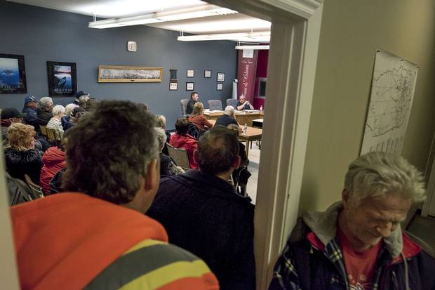 Wabana residents squeeze into a town council meeting where Mr. Crane is speaking. The council will be deciding at some later date whether to move the radio station out of the high school.