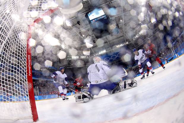 Feb. 18, 2018: Kim Wonjung of South Korea in hockey action with Wojciech Wolski of Canada.