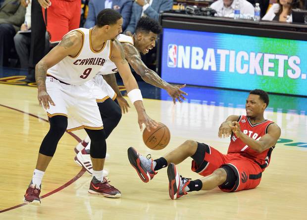 Kyle Lowry #7 of the Toronto Raptors attempts to pass the ball against Iman Shumpert #4 of the Cleveland Cavaliers and Channing Frye #9 during the second half in game two of the Eastern Conference Finals