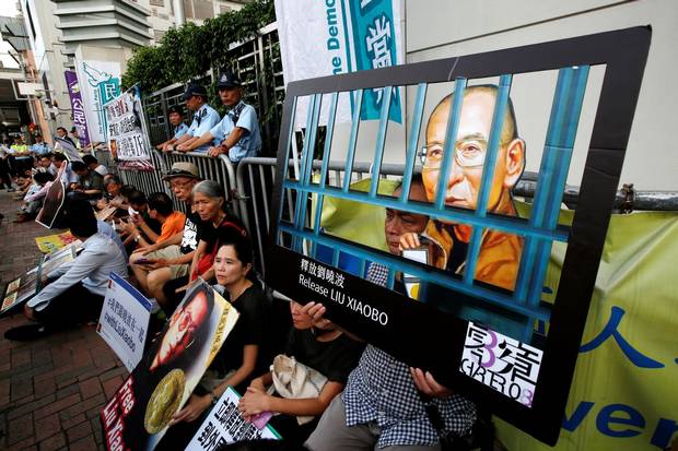 Pro-democracy activists stage a sit-in protest demanding the release of Nobel laureate Liu Xiaobo, outside China's Liaison Office in Hong Kong.