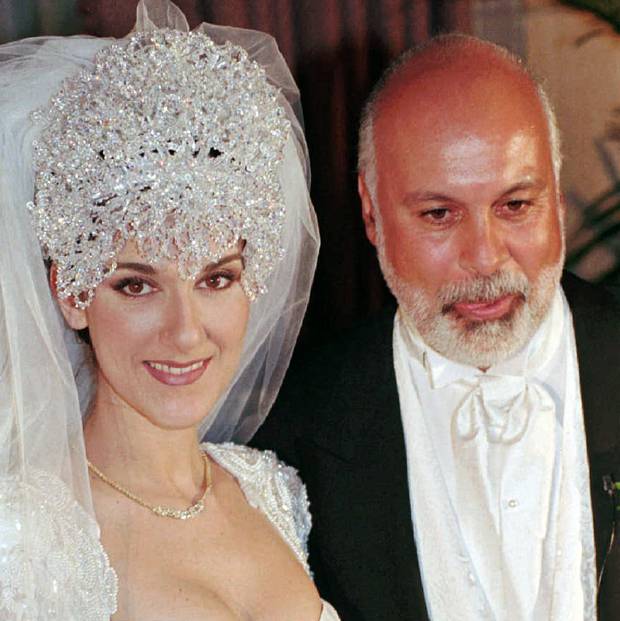 Quebec pop star Celine Dion and her husband, Rene Angelil, pose for photographers at a news conference following their wedding ceremony in Montreal in 1994.