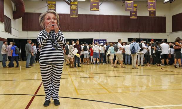 Supporter of Donald Trump, Beth Lyerla of Gilbert, Ariz., wears a Hillary Clinton mask and a prison outfit as she waits for the start of a campaign rally in Tempe, Ariz., on Oct. 27.