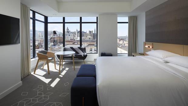 The hotel's design features a lot of pale greys and wood.