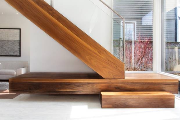 A larger step on the main staircase adds functionality and interest to the home's design.