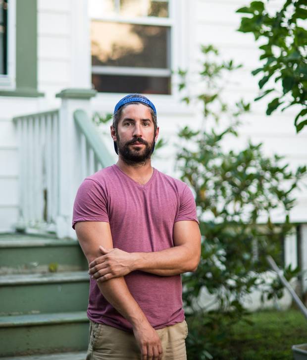Ross Higgins stands in front of his parents’ home in Halifax.