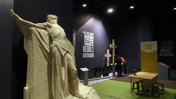 Workers put the final touches on the new display at the museum on Monday. The exhibit includes maquettes built by sculptor Walter Allward for the massive Vimy Ridge monument in France.