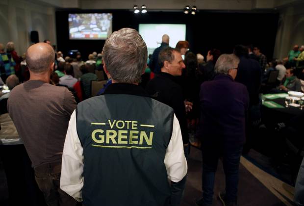 Green party supporters watch as results come in from election night.