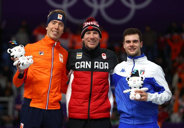 Left to right: Silver medalist Jorrit Bergsma of the Netherlands, gold medalist Ted-Jan Bloemen of Canada and bronze medalist Nicola Tumolero of Italy celebrate during the victory ceremony after the speed skating men's 10,000m.