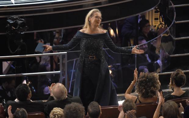 Meryl Streep stands for applause at the Oscars.