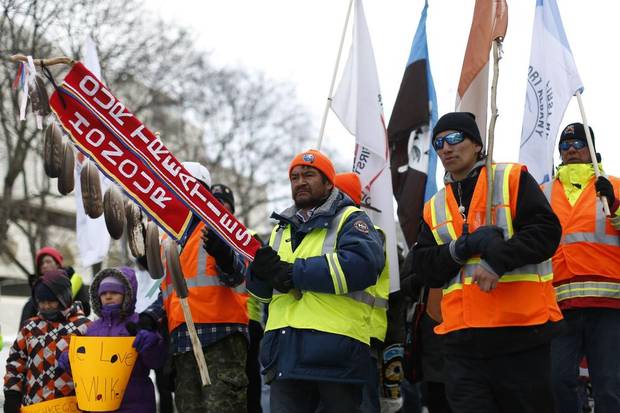 Danny Metatawabin, middle, walks with fellow Omushkegowuk Walkers and supporters while marching towards Parliament Hill in Ottawa on Feb. 24, 2014. 