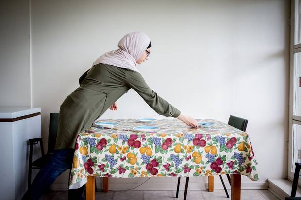 Mr. Sharbaji's youngest daughter, Sedra, sets the table as she prepares for lunch.