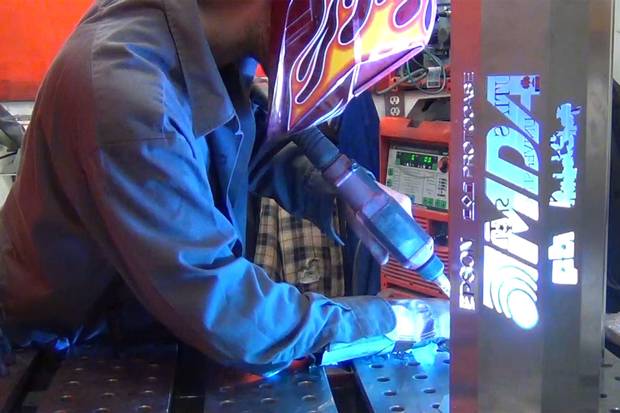 A Protocase staffer welds a custom order.
