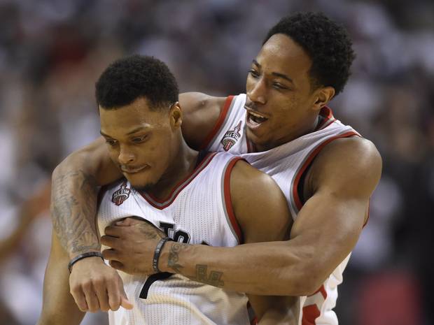 Toronto Raptors' DeMar DeRozan, right, and Kyle Lowry celebrate during a time out in the fourth quarter.