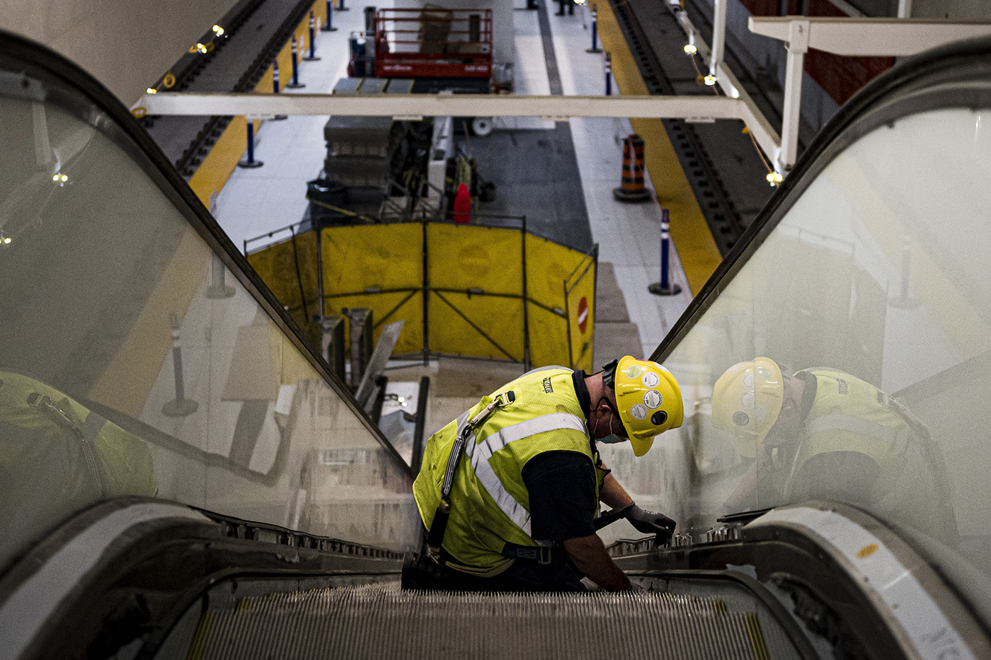 Technicians work on the escalator that leads to the main platform of the Science Center LRT station, photographed during a media tour of an eastern portion of the Eglinton Crosstown LRT line, in Toronto, on Tuesday, October 12, 2021