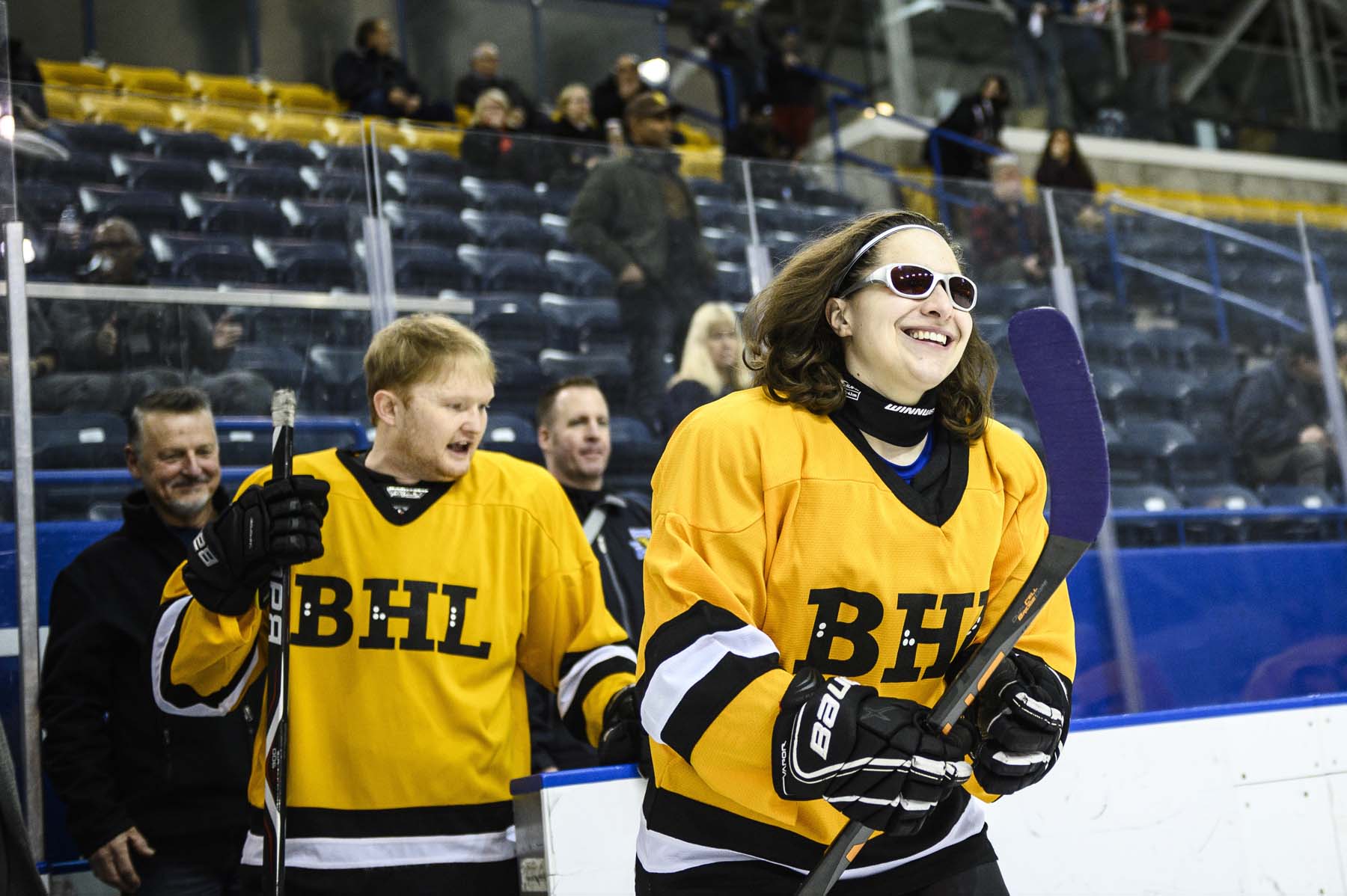 Amanda Provan, smiling, skates onto the ice at Toronto’s Mattamy Athletic Centre while people look on from the stands behind her.