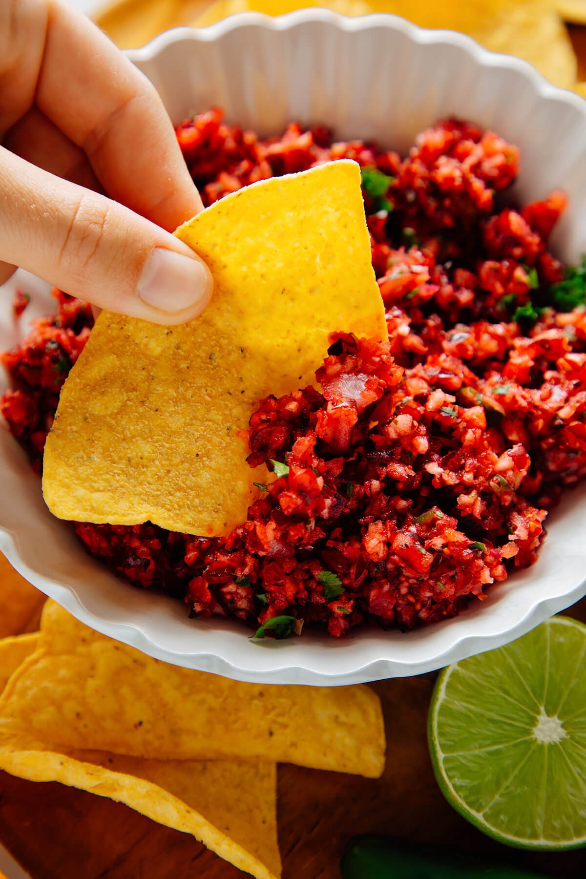 chip dipped into cranberry salsa
