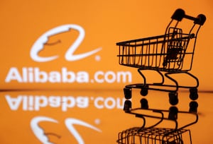FILE PHOTO: Shopping trolley is seen in front of Alibaba logo in this illustration, July 24, 2022. REUTERS/Dado Ruvic/Illustration/File Photo