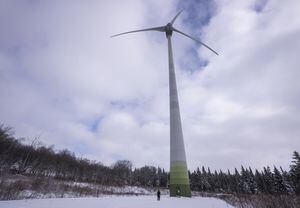 Samuel Drouin-Tardif, an electro-mechanic for Boralex, poses near a wind turbine in Thetford Mines November 24, 2023.