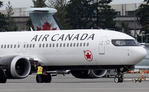 An Air Canada jet is moved on the tarmac at the airport, Wednesday, Nov.15, 2023 in Vancouver.
