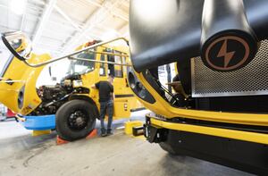 The Lion Electric Company says it is cutting 150 jobs or about 10 per cent of its workforce in a move to cut costs and improve its ability to reach its profitability objectives. The Lion C electric school bus logo is seen as they are assembled at the Lion Electric Company assembly plant in Saint-Jerome, Que., Monday, Aug. 21 2023. THE CANADIAN PRESS/Christinne Muschi