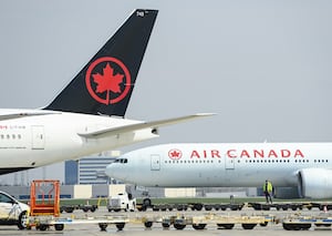 Air Canada planes sit on the tarmac at Pearson International Airport in Toronto on Wednesday, April 28, 2021.