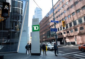 A TD sign on a post outside the TD Terrace building at Front St. West and Simcoe St. in Toronto’s Financial District, is photographed on Mar 4, 2024. (Fred Lum/The Globe and Mail)