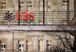 Logos of the Swiss banks Credit Suisse and UBS are seen on two buildings in Zurich, Switzerland, Saturday, March 18, 2023. (Michael Buholzer/Keystone via AP)