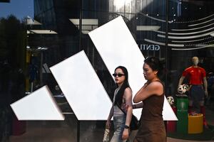 People walk past an Adidas store at a mall in Beijing on June 16, 2024. German sportswear giant Adidas has launched an investigation into alleged large-scale bribery in China after senior employees were accused of embezzling millions of dollars, the Financial Times reported on June 16. (Photo by Pedro PARDO / AFP) (Photo by PEDRO PARDO/AFP via Getty Images)