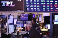 Traders work on the floor of the New York Stock Exchange during morning trading on August 12.