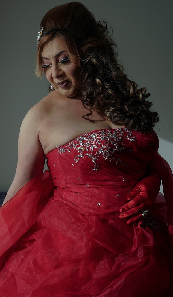 Dilian Quijano, 58, has her red dress ready for a quinceañera, a party usually given at age 15.