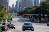 FILE PHOTO: A Tesla robotaxi drives on the street along South Congress Avenue in Austin, Texas, U.S., June 22, 2025. REUTERS/Joel Angel Juarez/File Photo