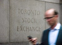 A man walks past a building in Toronto that used to house the Toronto Stock Exchange on Aug. 18 2011. 