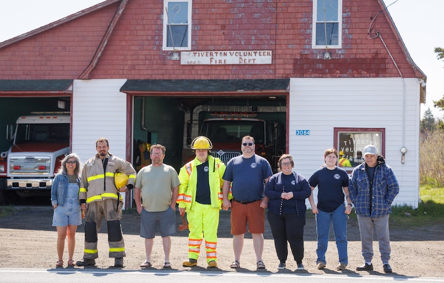 Volunteer firefighters line up in front of the fire station in Tiverton, Nova Scotia, in May, 2026. The building has been condemned since 2014.