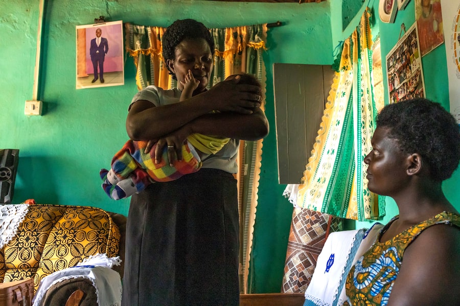  Health volunteer Christine Mubangizi, checking on a new mother and baby in southwestern Uganda, has spent years helping girls manage parenthood and make their way back to school.