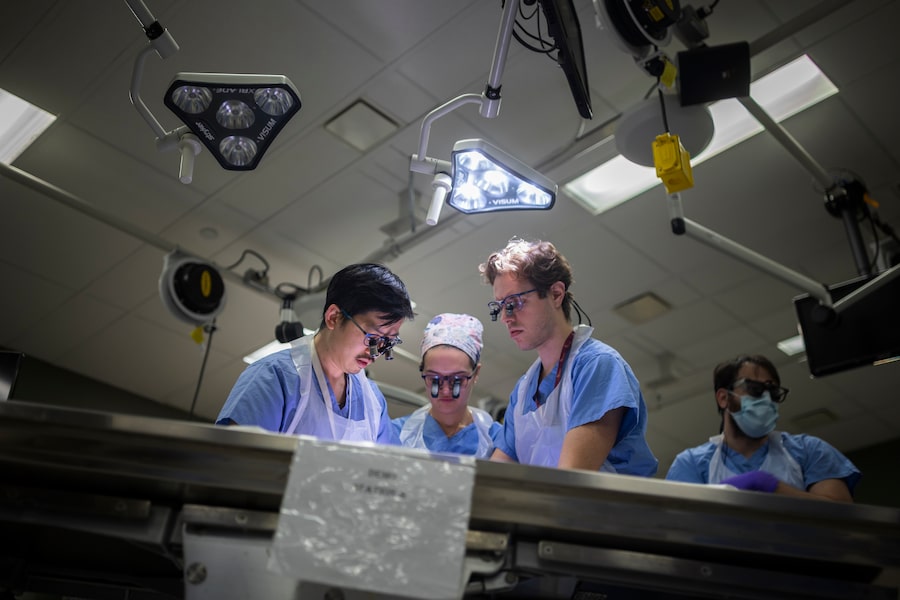 Surgical residents and fellows work on a table with a body donor during a peripheral nerve workshop in the anatomy lab at McMaster University in Hamilton on April 30.