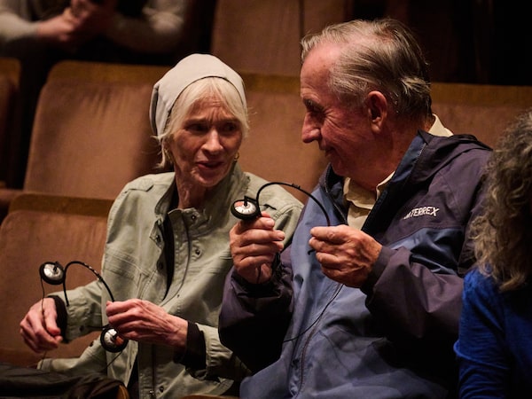 Audience members put on custom sound effect headphones before a preview run through of Medusa at Soulpepper theatre in Toronto on June 18.